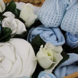 Blue booties and clothing in hamper basket