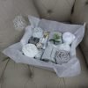 Tavistock Baby Gift Box - Clothing from hat to sleepsuit in a grey/white colour range and includes a soft cellular blanket and set of soft cotton muslins.