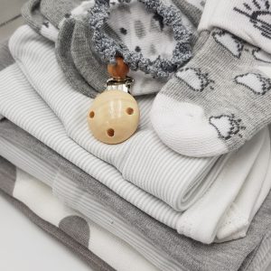 Silver Lining nappy cake displayed on a white background, featuring neatly arranged grey and neutral baby essentials, including a grey pacifier chain, baby clothes, and soft accessories, styled as an elegant unisex baby shower gift.