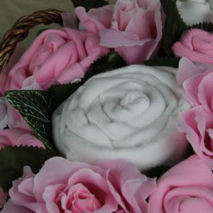Twins luxury bouquet pink displayed in gift basket with folded baby clothes flowers