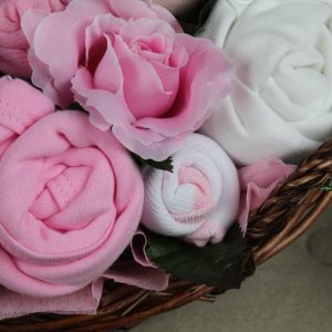 Twins luxury bouquet pink made from baby clothes arranged as flowers in a gift basket