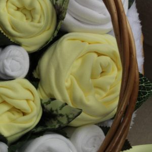 Rolled baby clothes in lemon colour
