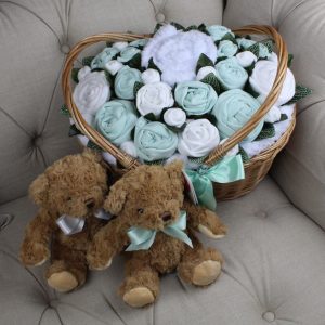 Twins Ultimate Bouquet in mint, featuring two sets of neatly arranged baby essentials including clothes, soft toys, and accessories, presented as a stylish and practical gift for newborn twins.