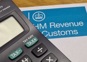 Photo of a HMRC form and a calculator