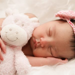 Best gift for a newborn baby - image of newborn with a soft teddy.